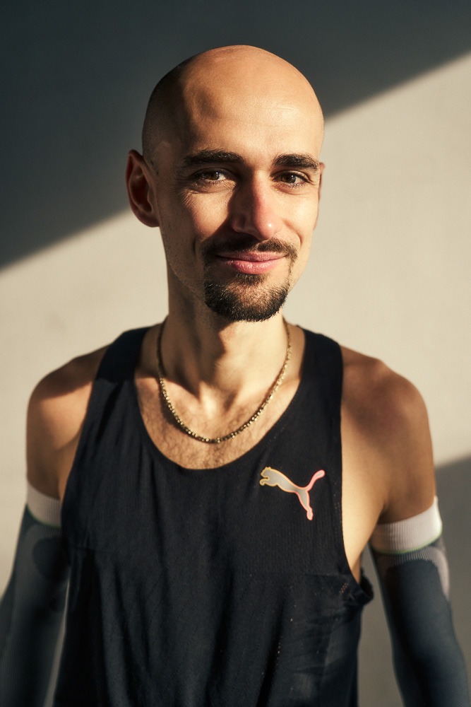 Hendrik Pfeiffer im Porträt nach dem Training. Porträt von Marathonläufer Hendrik Pfeiffer in Trainingskleidung mit Kompressions-Arm-Sleeves, aufgenommen in natürlichem Licht nach einer Trainingseinheit.