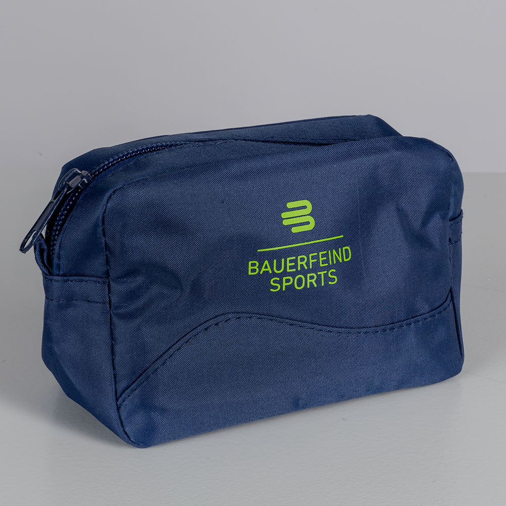 Minimalistisches Design: Die Bauerfeind Sports Kosmetiktasche im Studio Nahaufnahme einer kleinen, blauen Bauerfeind Sports Kosmetiktasche im Studio. Die Tasche ist schlicht gestaltet und zeigt das Bauerfeind-Logo in grün.